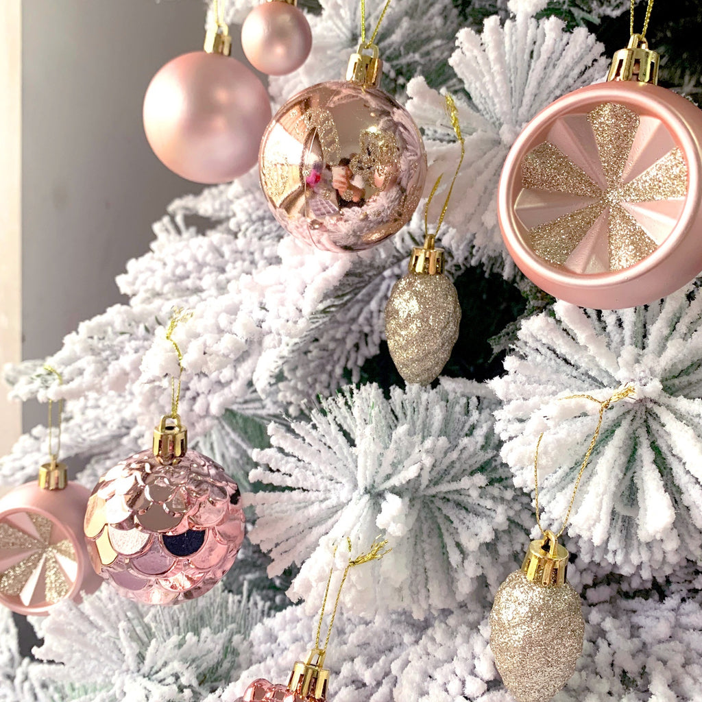 Christmas Ball Ornaments for Holiday Tree Decor hanging on a snow-covered Christmas tree.