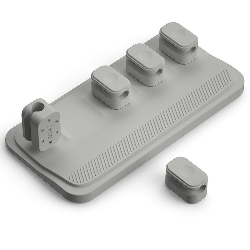 840c7552f1b9ba2623056a2023ceb609Charging cable wire holder with multiple ports for organized cable management on a desktop.