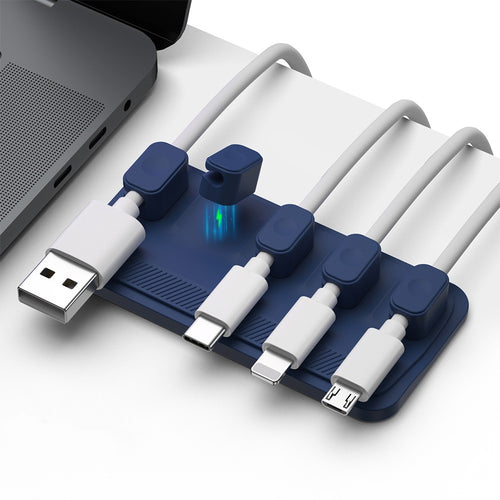 Charging cable wire holder with multiple ports for organized cable management on a desktop.